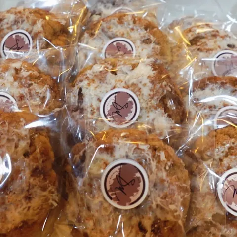 Iced, cinnamon-dusted cookies wrapped individually and sealed with SM stickers